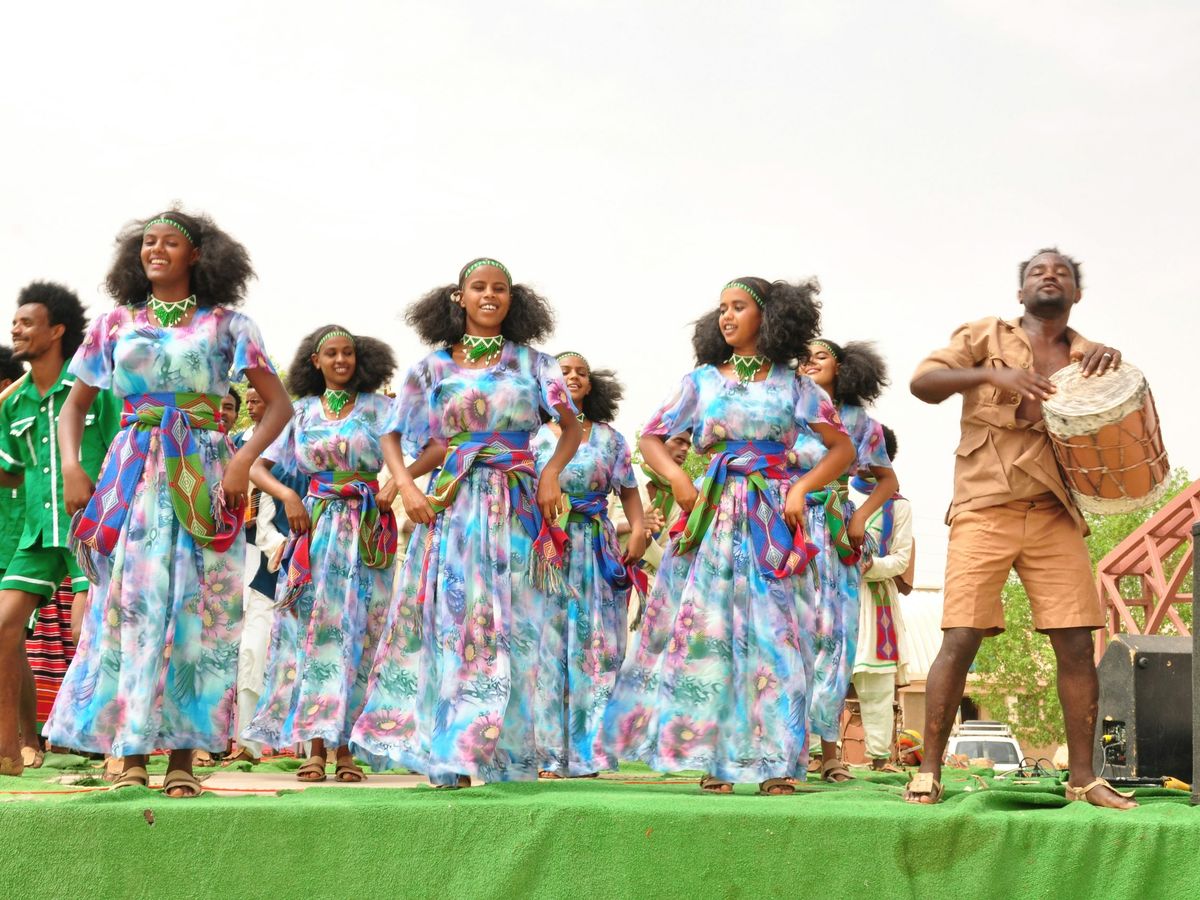 A group of performers standing together on a large stage